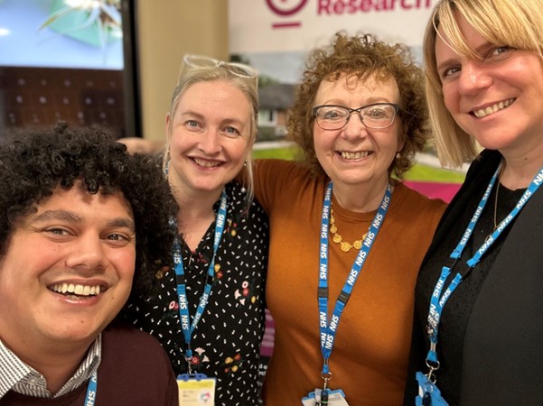 Four people smiling